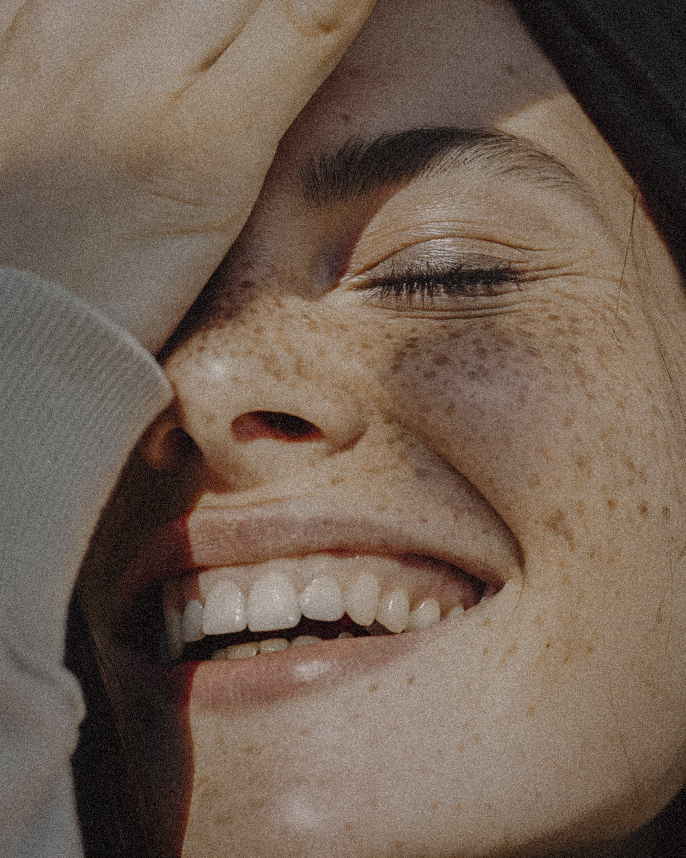 freckled_woman_smiling_in_sunlight.jpg